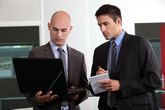 duo of young businessmen with laptop