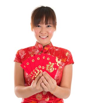 Pretty Asian woman with Chinese traditional dress cheongsam or qipao holding ang pow or red packet monetary gift. Chinese new year concept, female model isolated on white background.