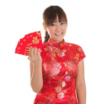 Pretty Asian girl with Chinese traditional dress cheongsam or qipao holding ang pow or red packet monetary gift. Chinese new year concept, female model isolated on white background.