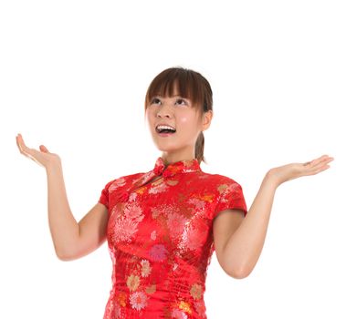 Pretty Asian woman with Chinese traditional dress cheongsam or qipao open arms looking up surprisingly. Chinese new year concept, female model isolated on white background.