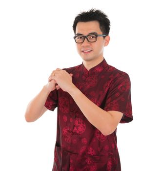 Asian male with Chinese traditional dress cheongsam or tang suit greeting. Chinese new year concept, male model isolated on white background.