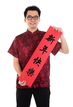 Asian man with Chinese traditional cheongsam or tang suit holding couplet, the Chinese word means Happy New Year.  Male model isolated on white background.