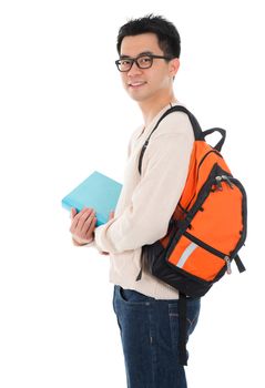 Handsome Asian adult student in casual wear with school bag carrying text books standing isolated on white background. Asian male model.