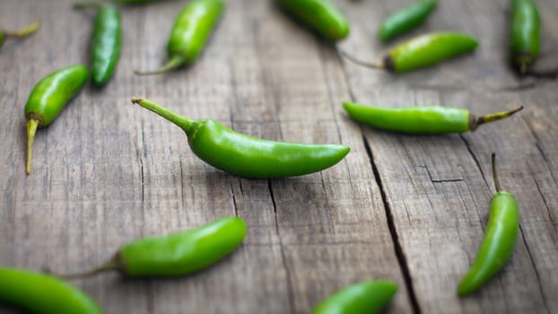 Green Jalapenos chili pepper on wooden background