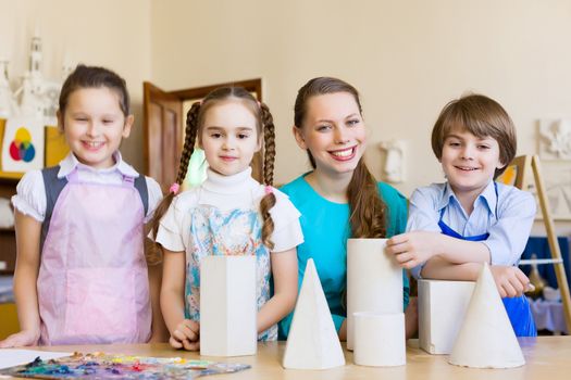 Little children painting and playing at kindergarten