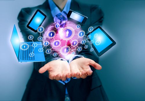 Image of business person holding devices in hands