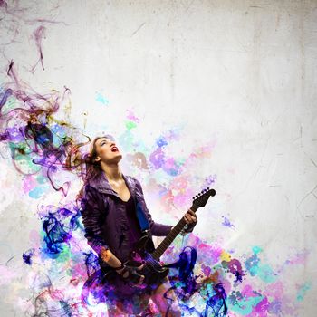 Young attractive rock girl playing the electric guitar