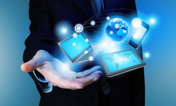 Image of business person holding devices in hands