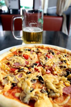 image of tasty pizza with glass of beer