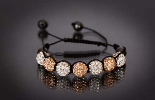 Popular Buddhist bracelet shamballa on a black background