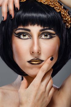 Close-up portrait of a beautiful girl with an evening make-up and jewelery