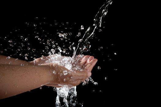 file of hand and pouring water on black background