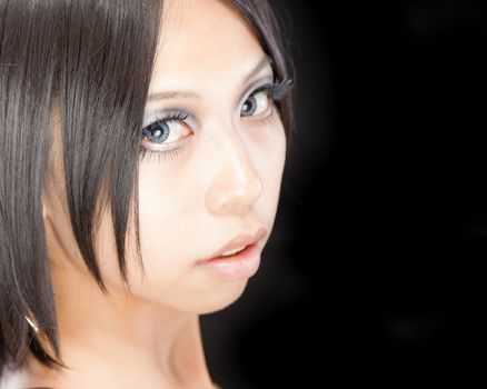 Asian female portrait on isolated black background