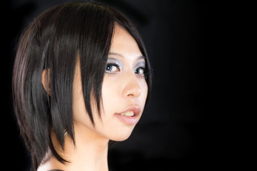 Asian female portrait on isolated black background