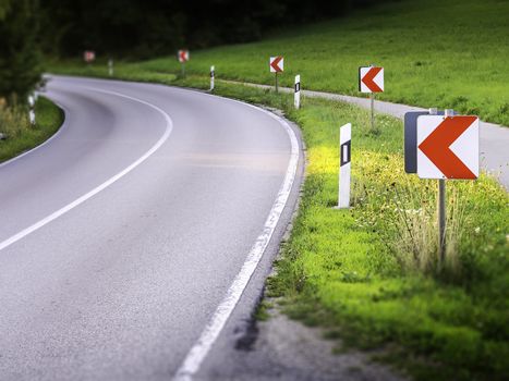 Dangerous road curve with warning signs