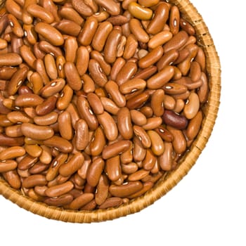 Wicker plate with grains beans close-up on white background