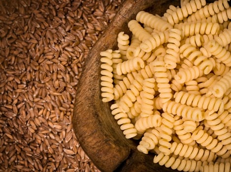 pile of fusilli pasta close up on wood background