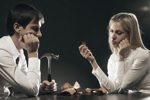 Portrait of young couple unhappy about their savings 
