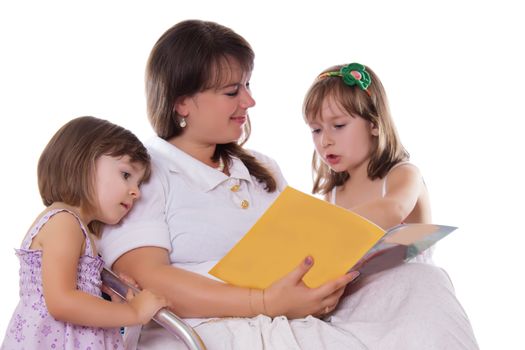 Two daughters listening their mother reading book isolated on white