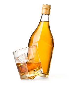 glass and bottle of whiskey on a white background