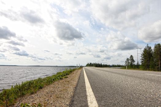 Summer landscape with road, gulf and forest