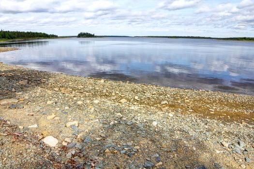 Finnish landscape with a forest lake with stones