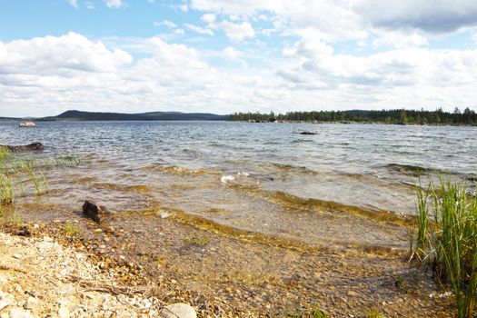 Beautiful landscape with close-up of lake shore and view on islands