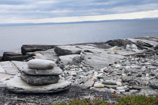 Stack of rocks on ocean coast of northern Norway fjord