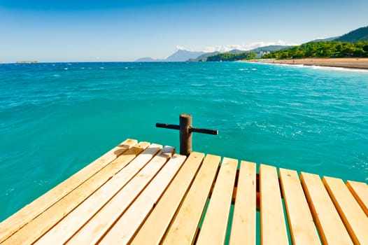 wooden pier in the sea, the view of the mountains in the distance