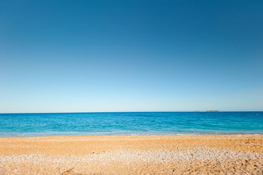 sand-and-pebble beach and a quiet, calm sea