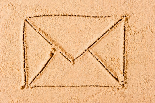 envelope is drawn on wet sand on the beach