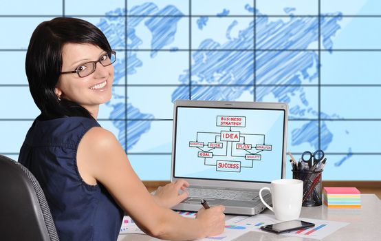 woman with laptop sitting in office, business concept