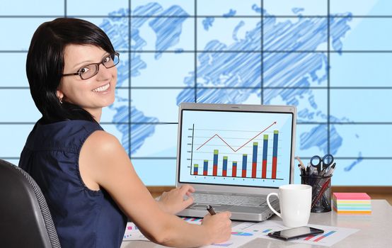 woman and chart on screen laptop sitting in office