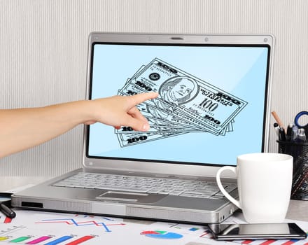 hand pointing to screen laptop with dollars