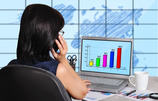 woman and chart on screen laptop sitting in office