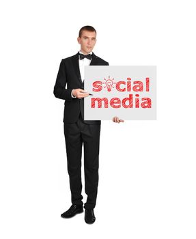 businessman in tuxedo holding poster with social media