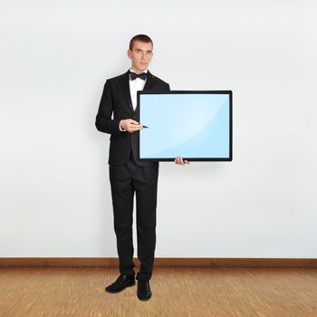 businessman in room holding blank plasma
