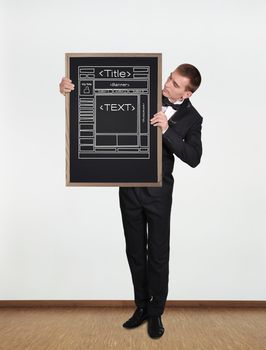 businessman standing in office and  holding blackboard with template web page