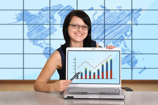 woman sitting in office and laptop with chart