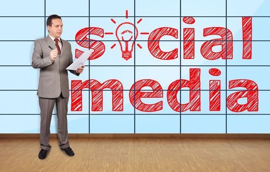 businessman in office and social media on plasma wall
