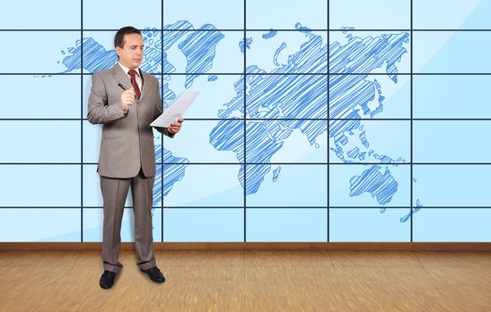 businessman in office and world map on plasma wall