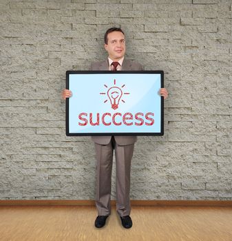 businessman in room holding plasma with success symbol