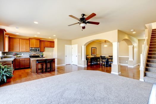 New home kitchen interior and large empty living room.