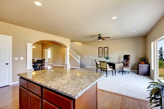 New home kitchen interior with dark brown cabinets and hardwood floors.