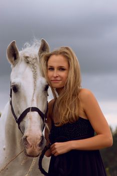 Blond girl with white horse