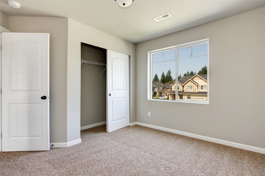 New empty room with beige carpet.. New house development in USA.