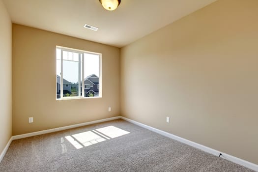 New empty room with beige carpet.. New house development in USA.