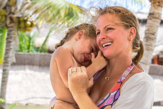 Mother and daughter close to each other outside having fun time