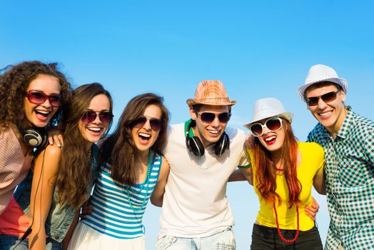 group of young people wearing sunglasses and hats hugging and standing in a row, spending time with friends