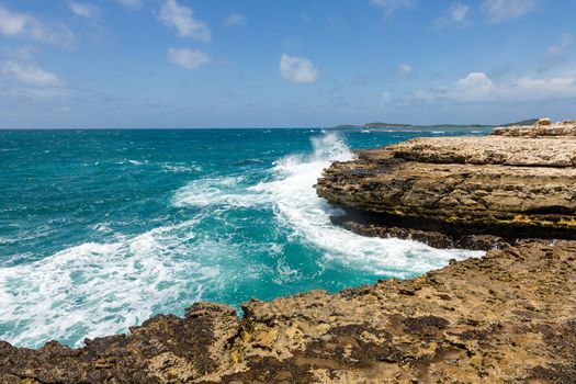 Devil's Bridge Antigua Waves Crashing on Rocky Limestone Coastline in Sunshine